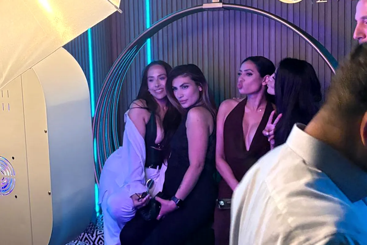 Guests posing at a milestone birthday photo booth